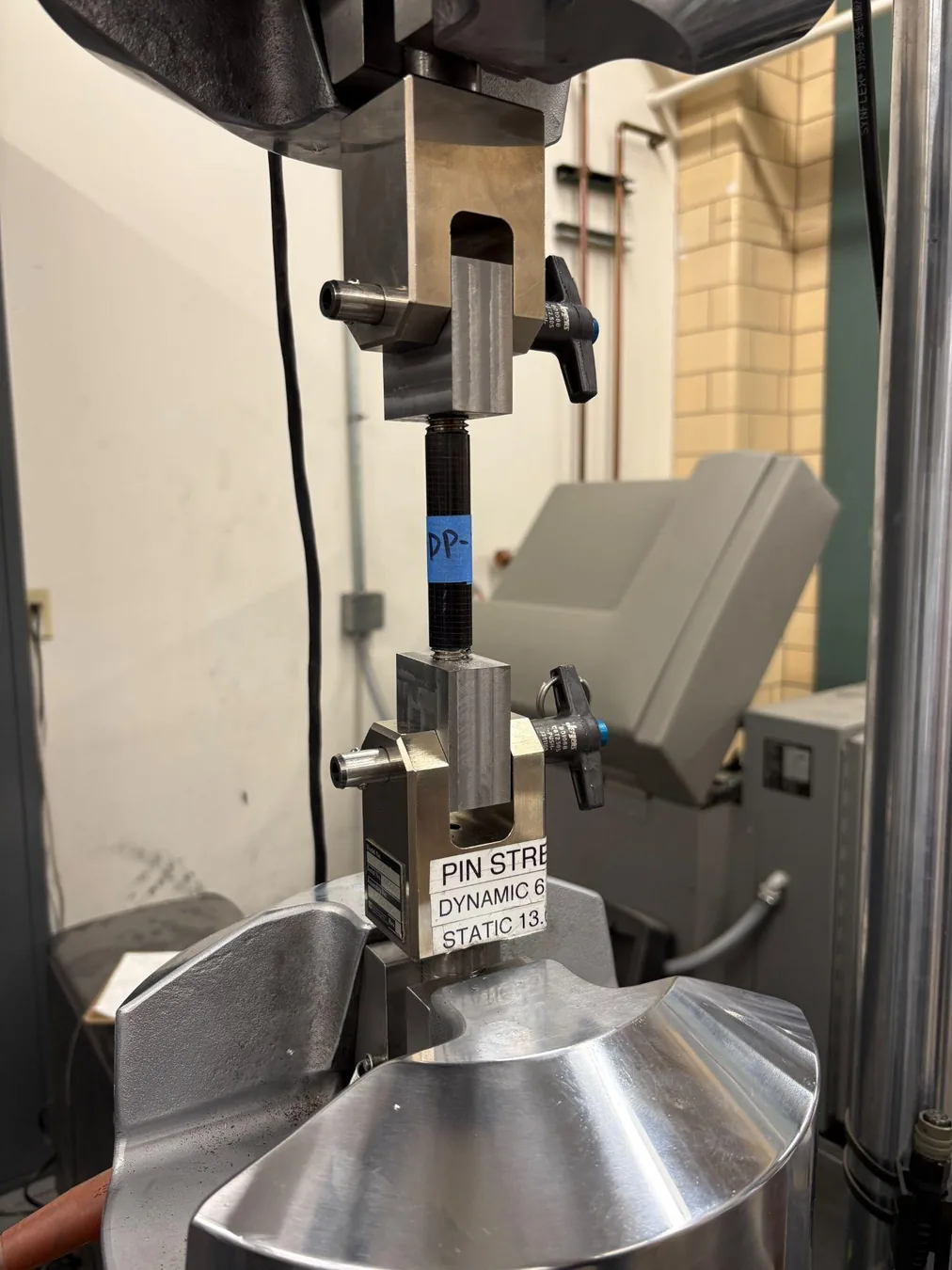 Carbon-fiber insert specimen mounted in an MTS tensile test frame